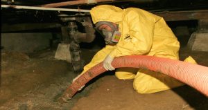 sewage cleanup technician using hose